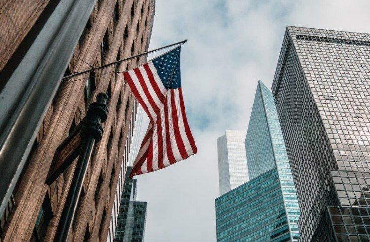 USA flag near skyscrapers