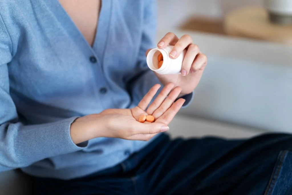 woman holding pills